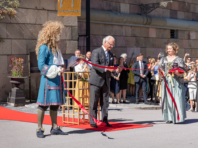 King Carl XVI Gustaf cuts the ribbon outside of The Royal Armoury