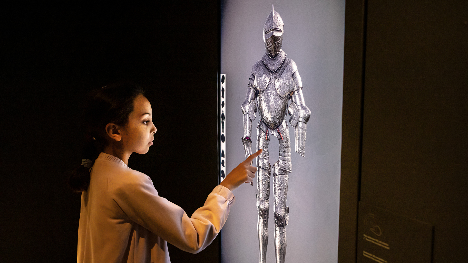 A child in front of a touch screen.