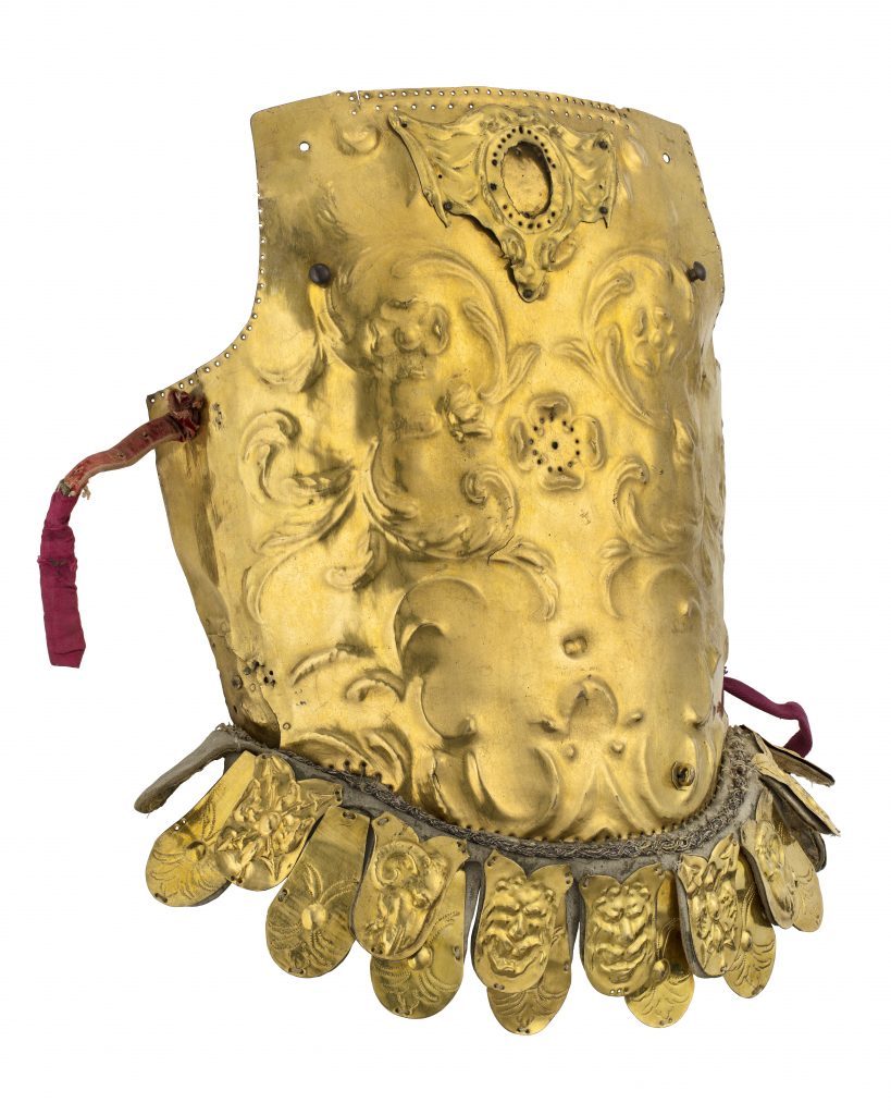 A gilt breast plate.