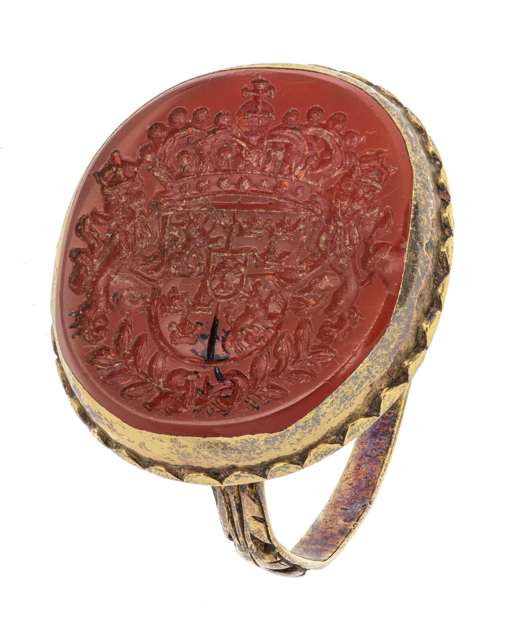 A ring of gold with a large red disc engraved with a coat of arms.
