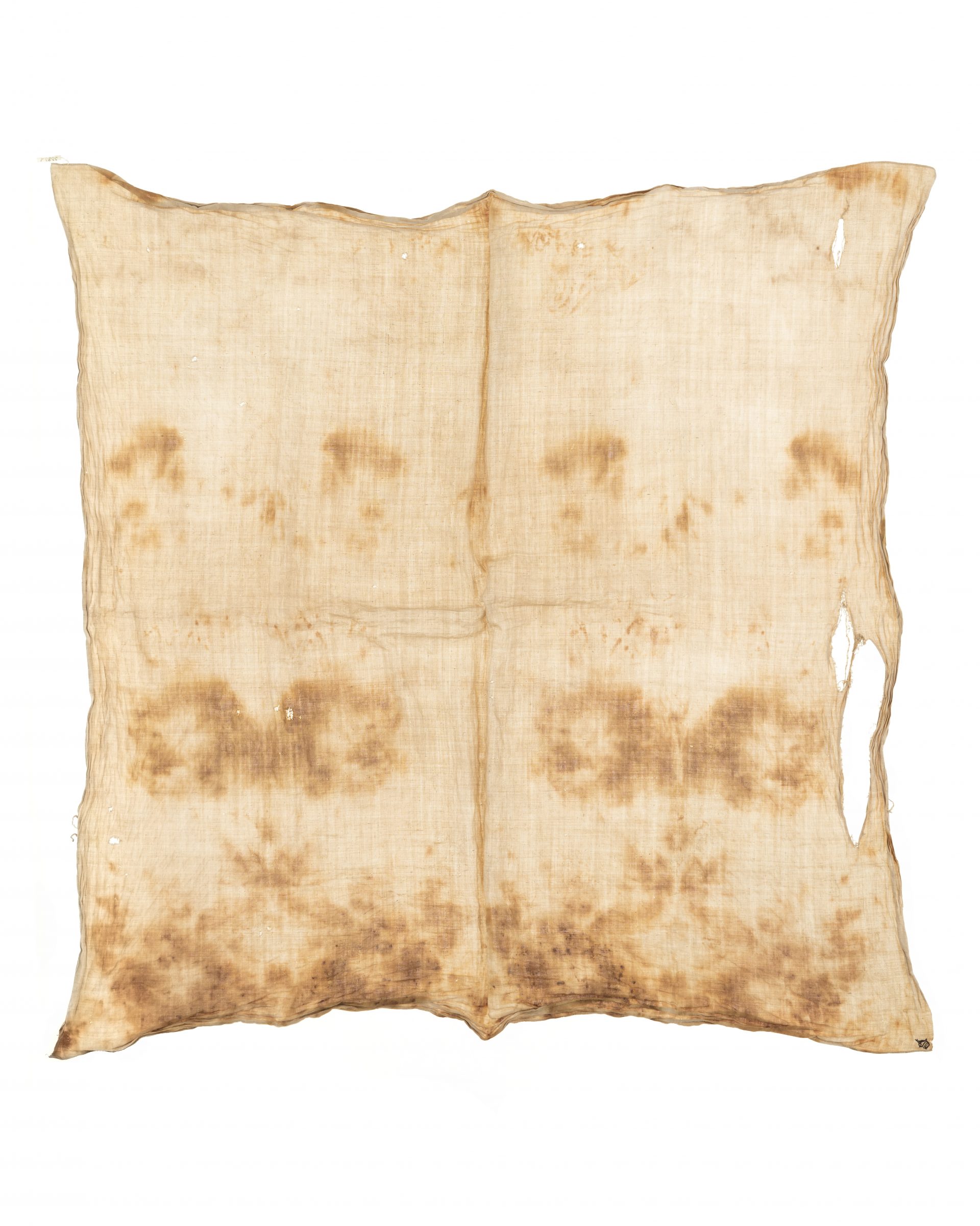 A square piece of cloth, yellowed by age and blood.