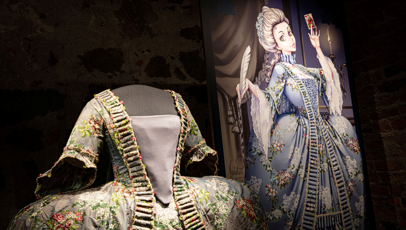 En blommig 1700-talsklänning tillsammans med en mangateckning föreställande klänningen. 