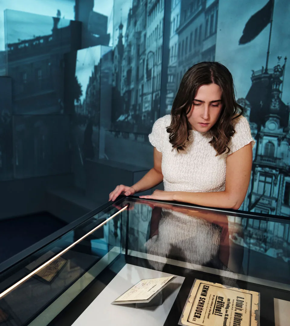 Person looking in a display case in an exhibition