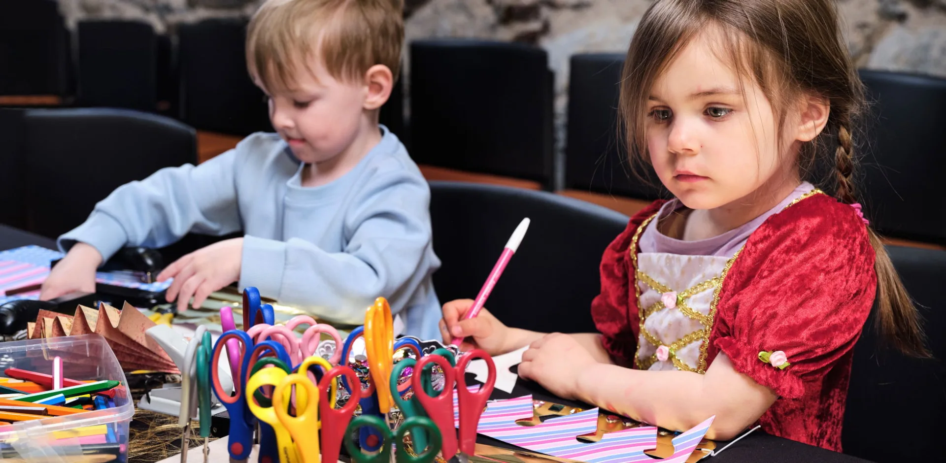 Two children doing crafts.